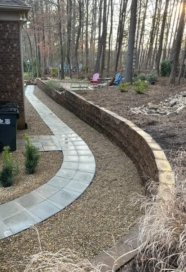 charlotte-retaining-walls Construction of a curved brick pathway in Charlotte, showcasing expert hardscaping techniques.